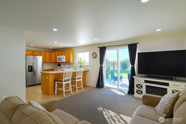 an aerial view of a house with a garden and lake view