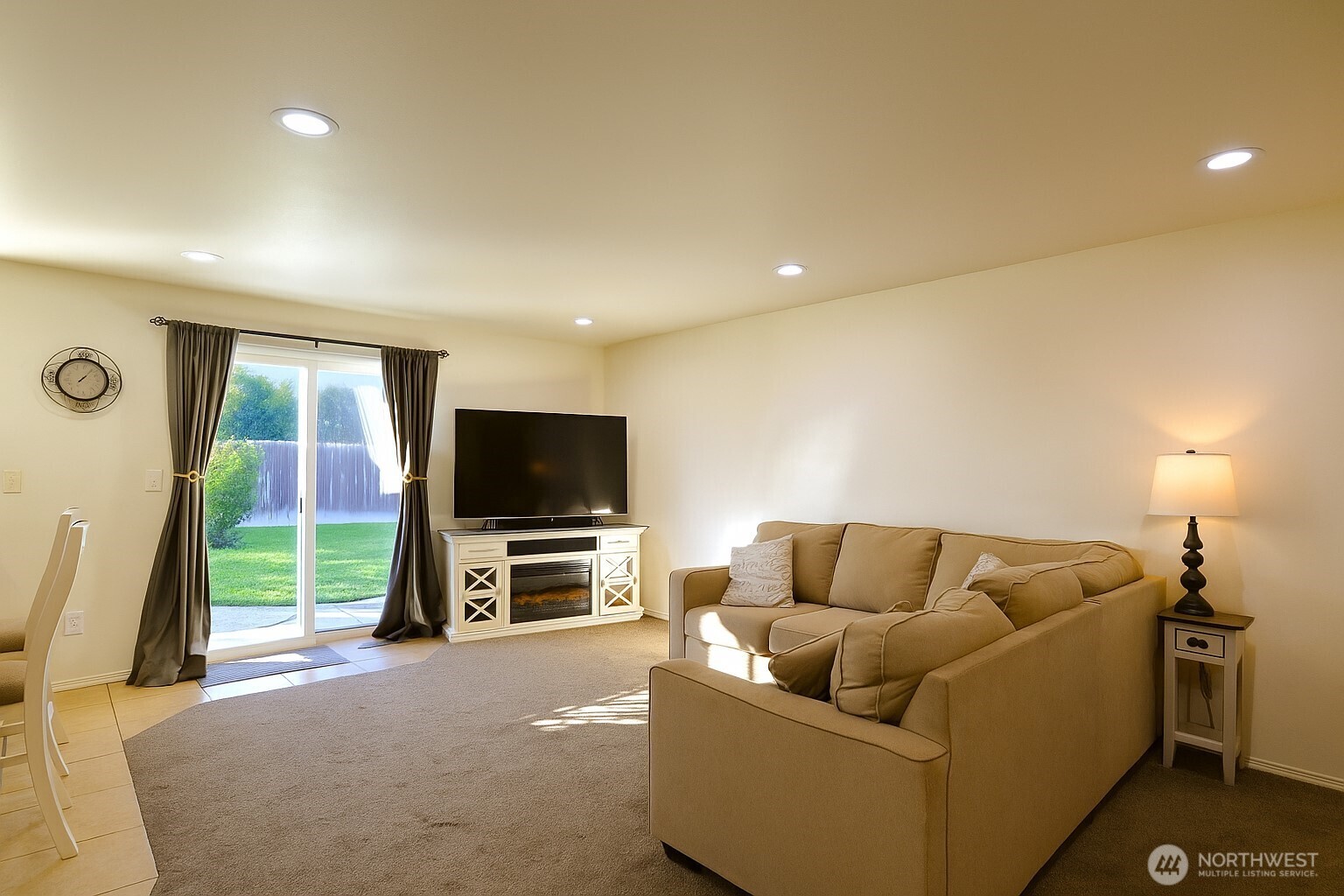 526 Monarch Street Moses Lake, WA 98837 - Photo 22 of 38 a living room with furniture and a flat screen tv