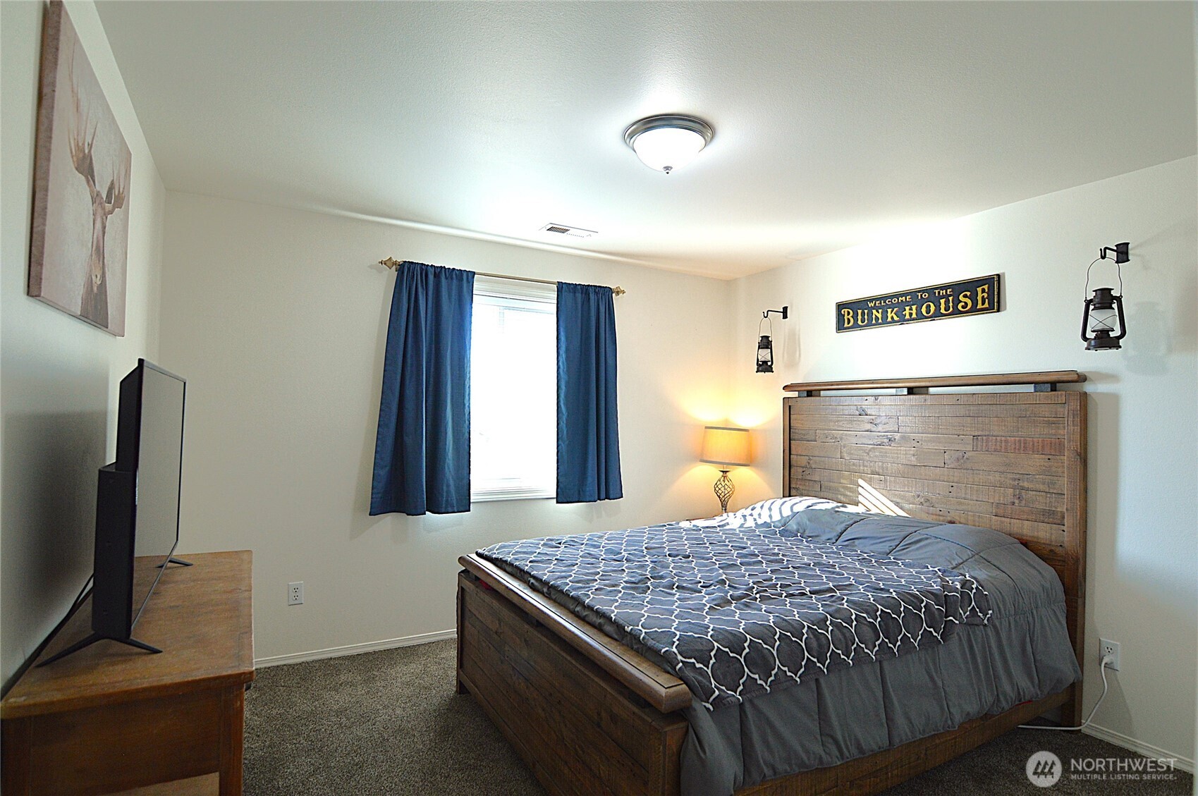 526 Monarch Street Moses Lake, WA 98837 - Photo 28 of 38 a bedroom with a bed and a flat screen tv