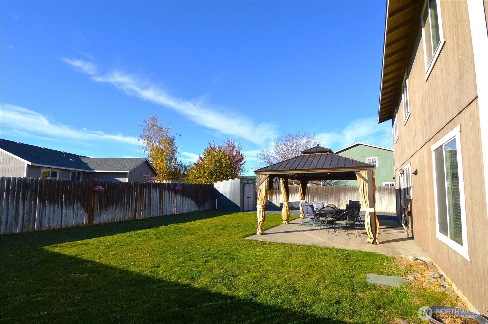 526 Monarch Street Moses Lake, WA 98837 - Photo 33 of 38 a view of a patio with table and chairs under an umbrella