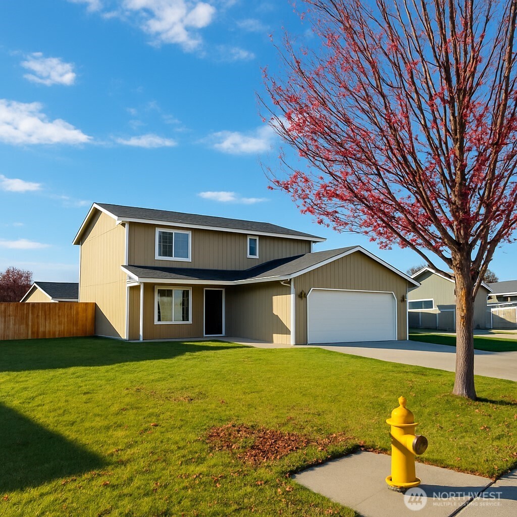 526 Monarch Street Moses Lake, WA 98837 - Photo 10 of 38 a front view of a house with garden