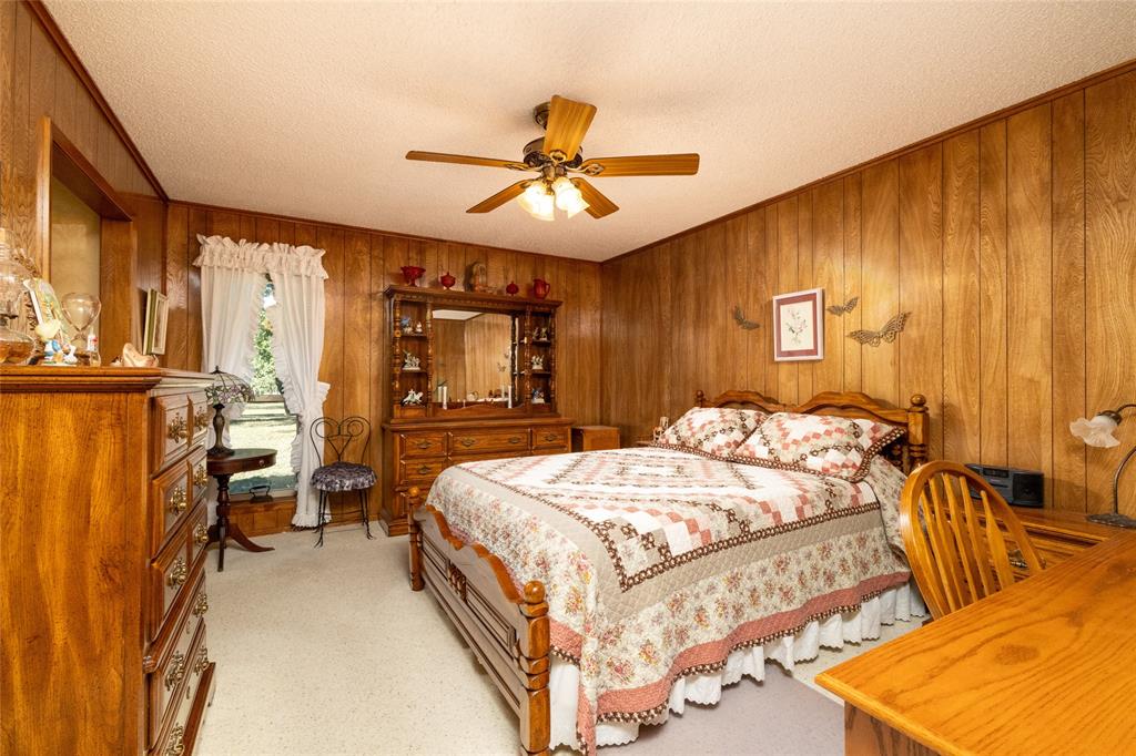 970 Live Oak Road Santo, TX 76472 - Photo 30 of 40 a bedroom with a bed and wooden floor
