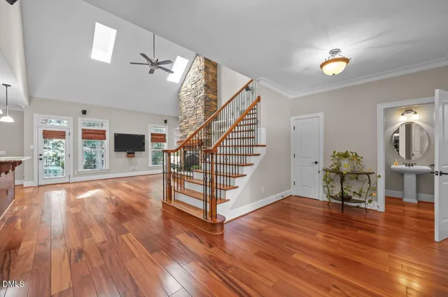 a view of a livingroom with wooden floor and furniture