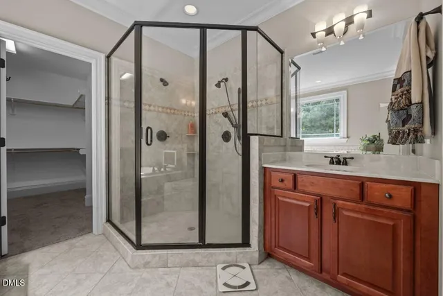 a bathroom with a shower sink and mirror