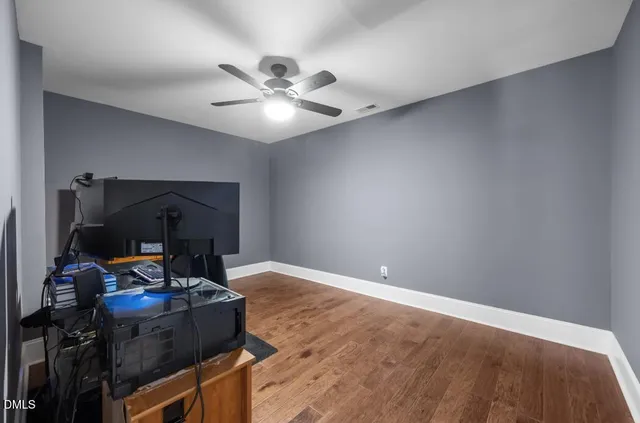 a living room with furniture and a ceiling fan