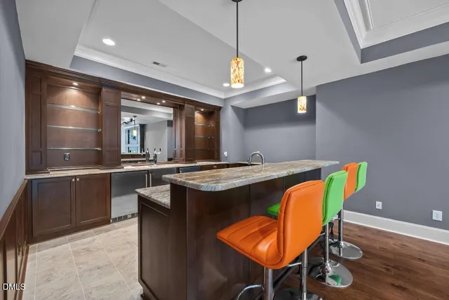 a kitchen with stainless steel appliances granite countertop a stove a refrigerator a sink with a dining table and chairs