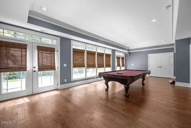 a view of a livingroom with wooden floor and a large window