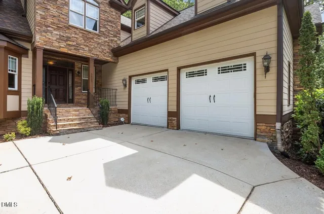 a view of a patio with table and chairs with wooden floor and fence