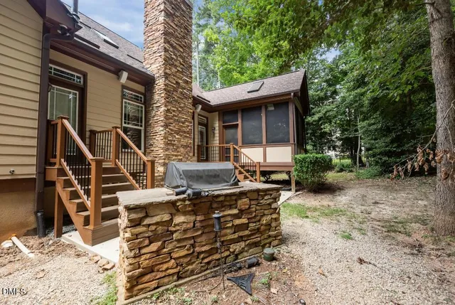 a aerial view of a house with a yard and potted plants