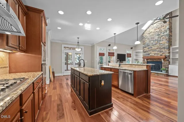 a kitchen with stainless steel appliances granite countertop a stove and a refrigerator