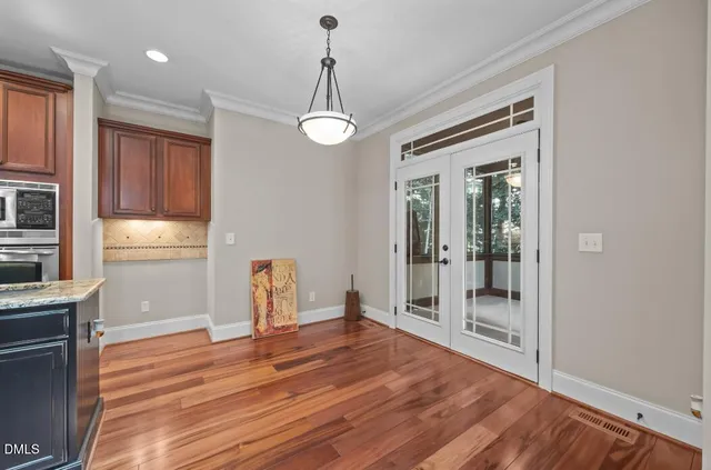 a view of a room with wooden floor and window