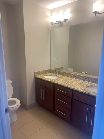a bathroom with a granite countertop bathtub shower and a sink