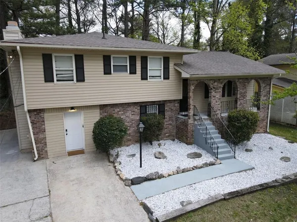 a front view of a house with garden