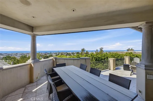 a view of a balcony with wooden floor and outdoor seating