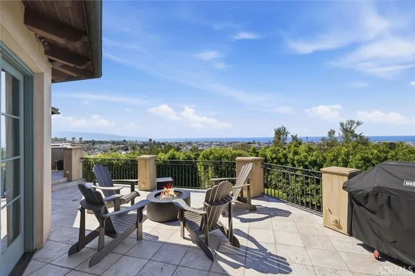 a view of a terrace with furniture and a garden
