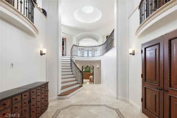 a view of a hallway with entryway wooden floor and dining room view