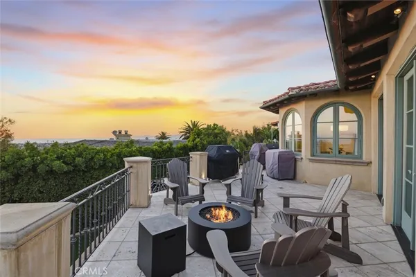 a view of a balcony with furniture and a garden