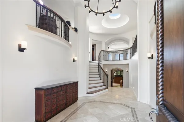 a view of a hallway with entryway wooden floor and front door