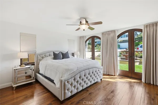a bedroom with a large bed and a chandelier