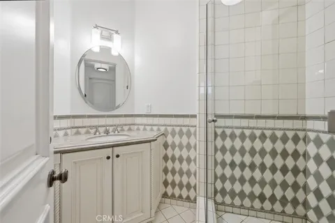 a bathroom with a mirror and a shower