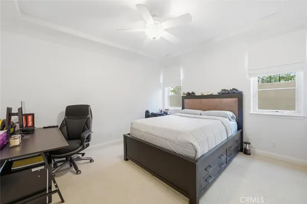 a bed room with a bed window and a desk