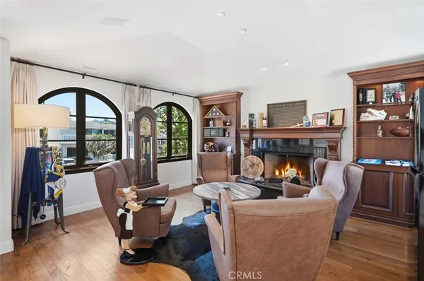 a living room with furniture a fireplace and a large window