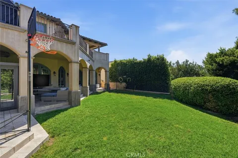 a front view of a house with garden and patio