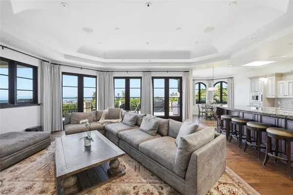 a living room with furniture potted plant and a large window