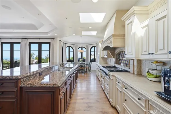 a very nice looking kitchen with granite countertop a large window