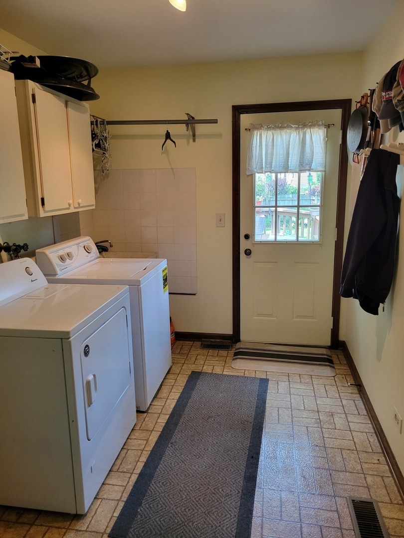1263 Bainbridge Drive Naperville, IL 60563 - Photo 22 of 31 a utility room with cabinets washer and dryer