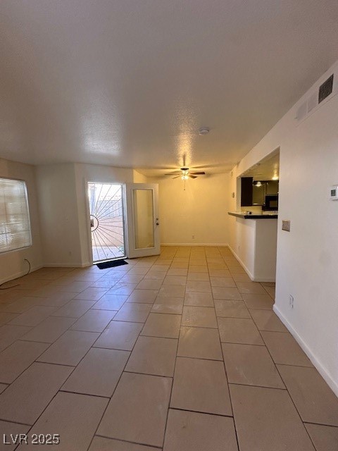 1830 North Pecos Road, Unit 155 Las Vegas, NV 89115 - Photo 5 of 23 Spare room with light tile patterned floors, ceiling fan, and baseboards