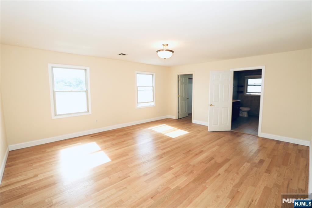 23 Main Avenue Wallington, NJ 07057 - Photo 15 of 29 an empty room with wooden floor and windows