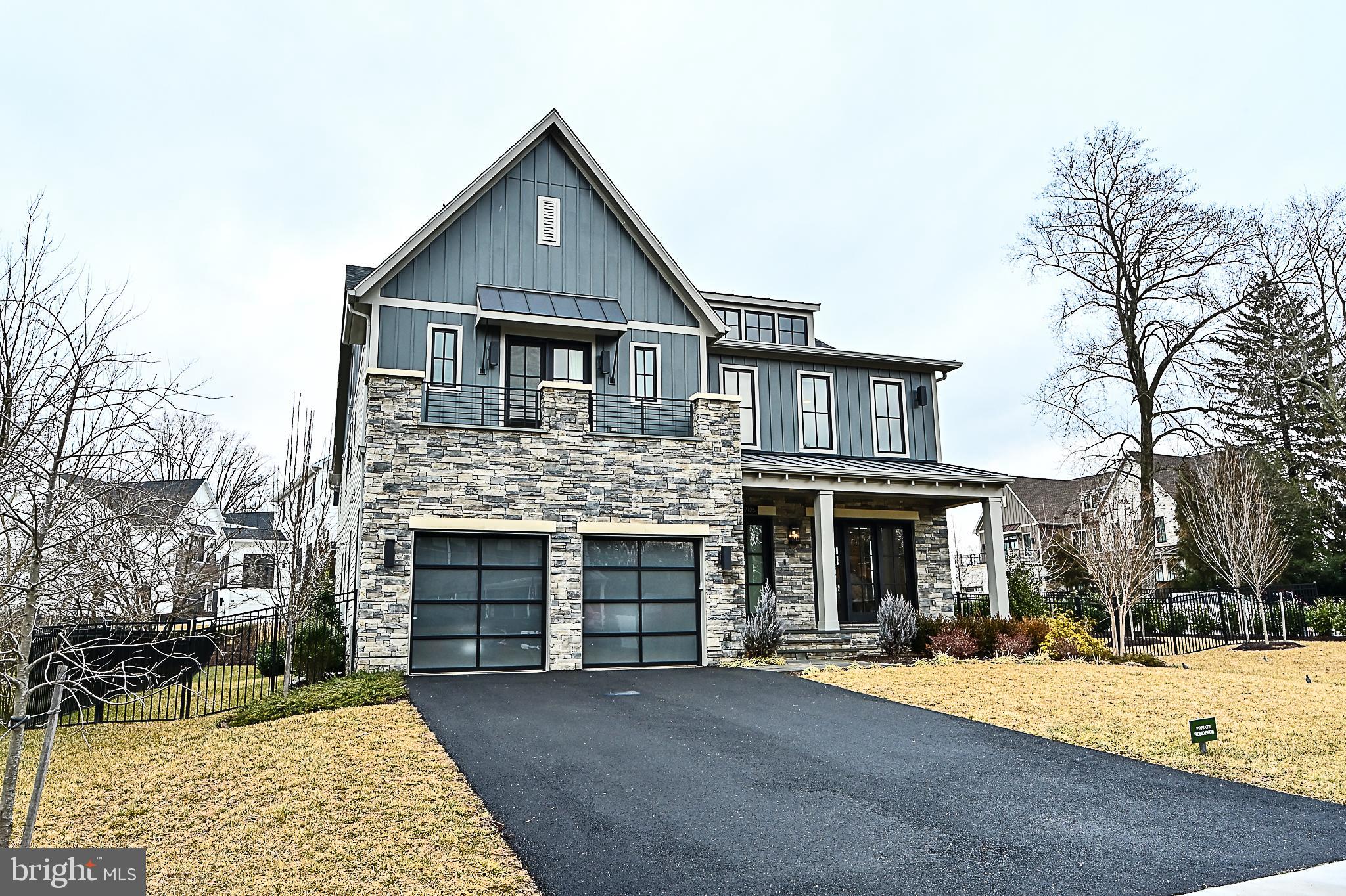 7126 Merrimac Drive McLean, VA 22101 - Photo 3 of 98 a front view of a house with a yard and garage