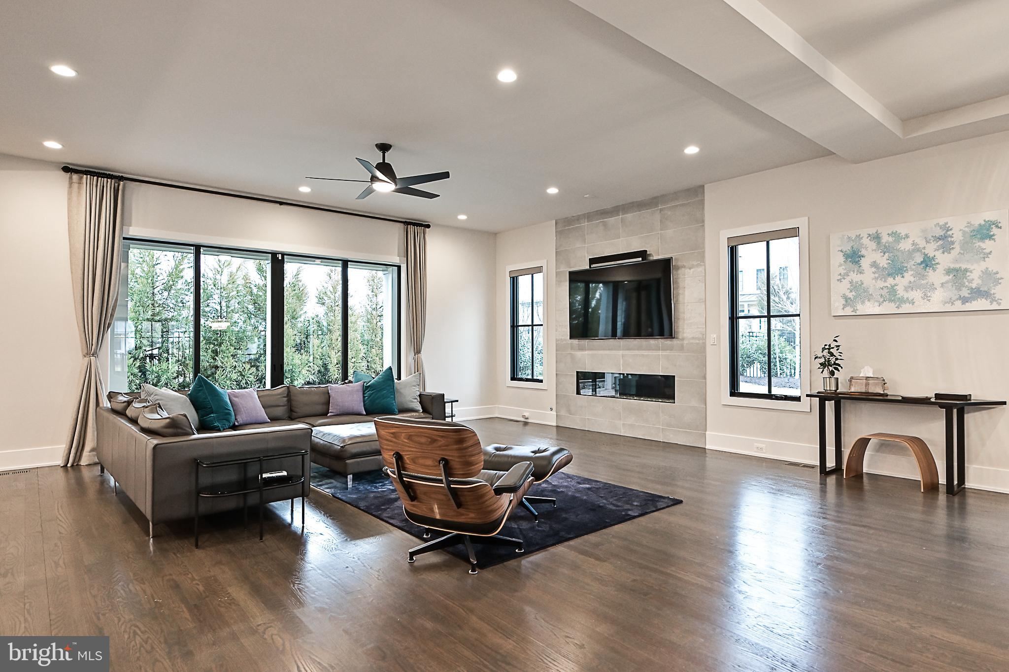 7126 Merrimac Drive McLean, VA 22101 - Photo 28 of 98 a living room with furniture flat screen tv and wooden floor