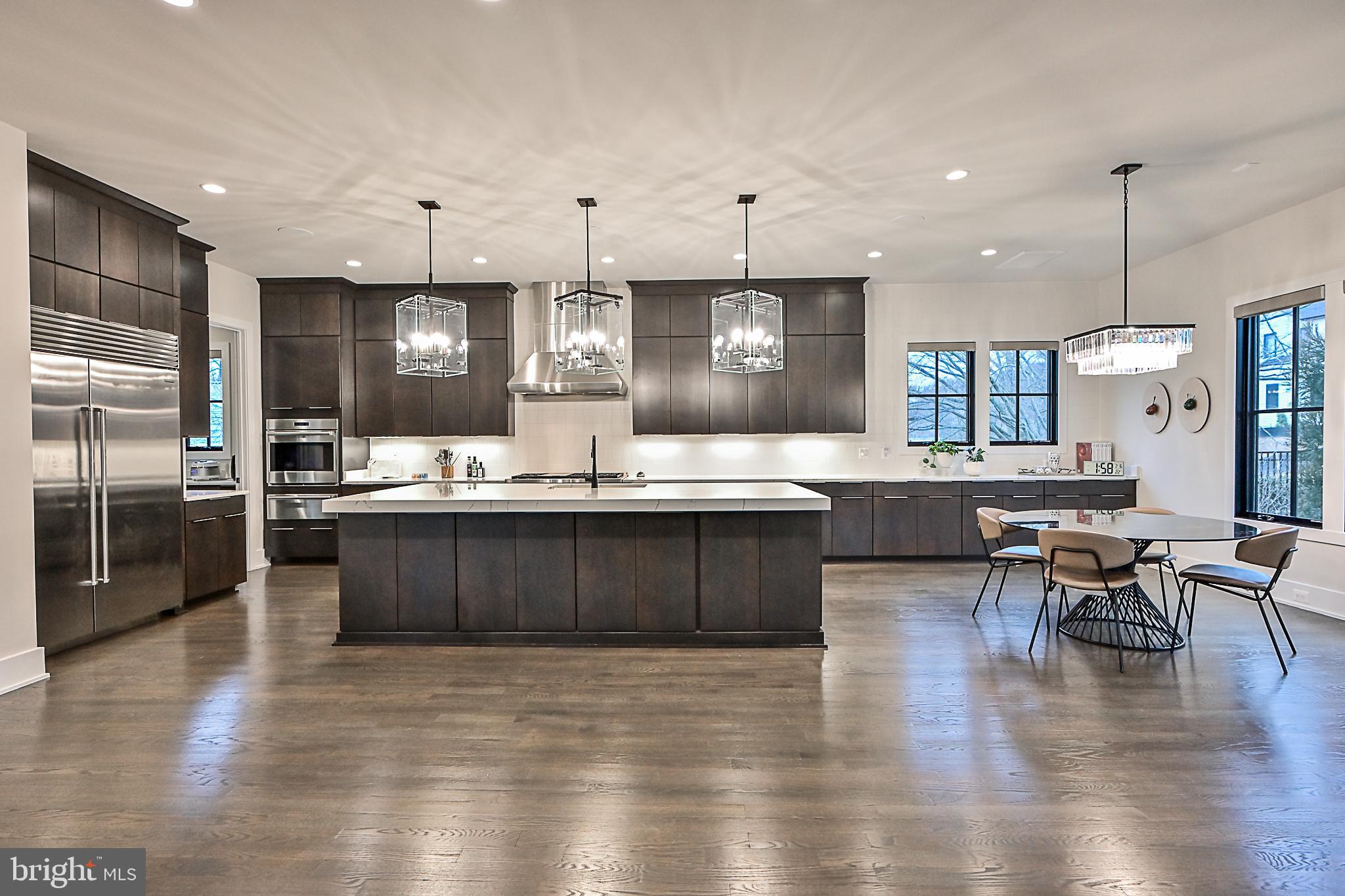 7126 Merrimac Drive McLean, VA 22101 - Photo 34 of 98 a large kitchen with a large counter top space a sink stainless steel appliances and cabinets