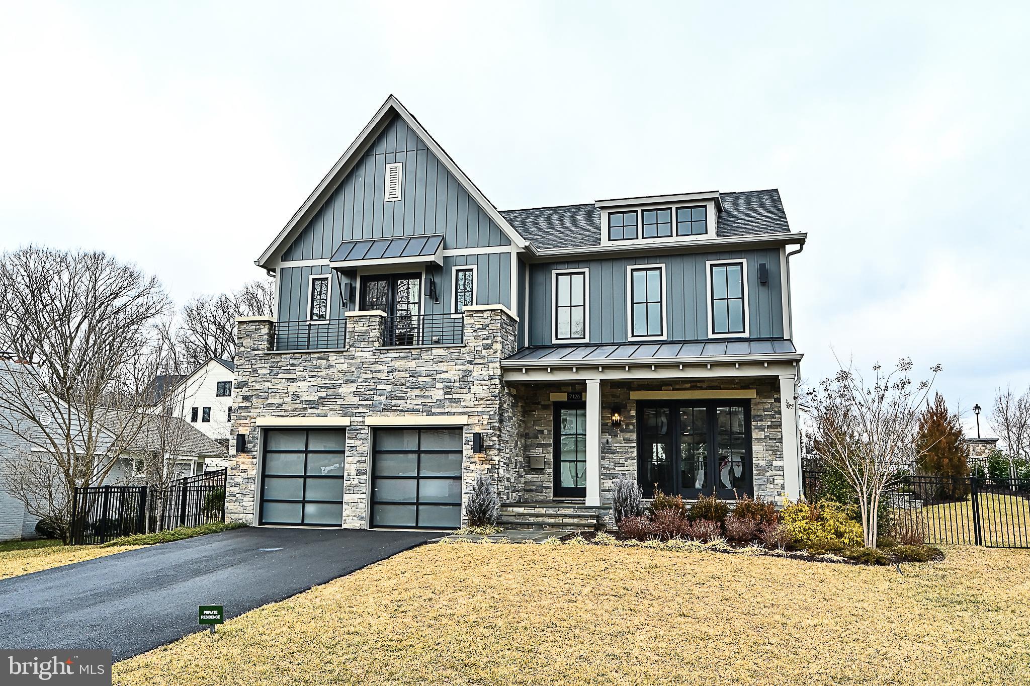7126 Merrimac Drive McLean, VA 22101 - Photo 5 of 98 a front view of a house with a yard outdoor seating and garage