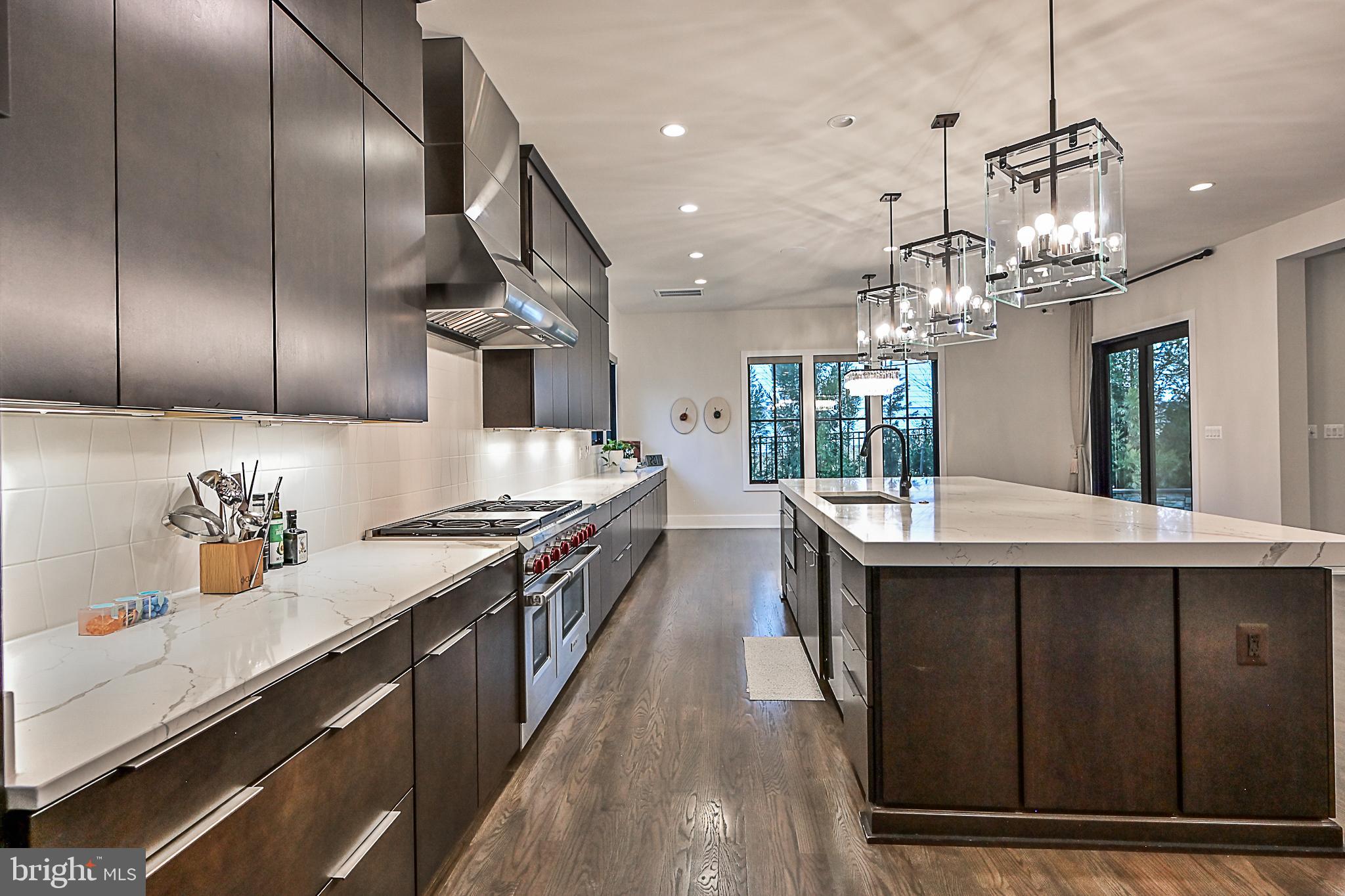 7126 Merrimac Drive McLean, VA 22101 - Photo 42 of 98 a kitchen with stainless steel appliances granite countertop a sink a stove and a wooden floors