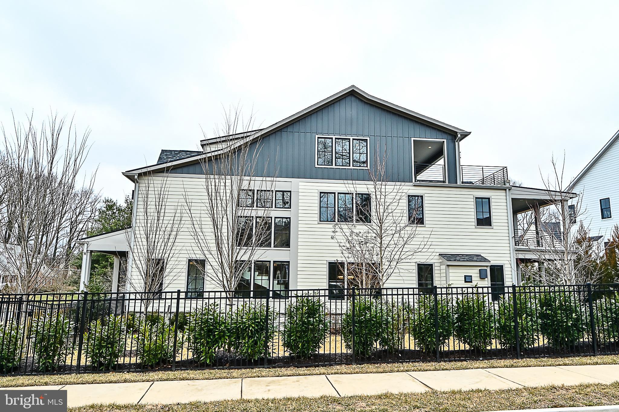 7126 Merrimac Drive McLean, VA 22101 - Photo 8 of 98 a view of a white house with large windows and palm tree