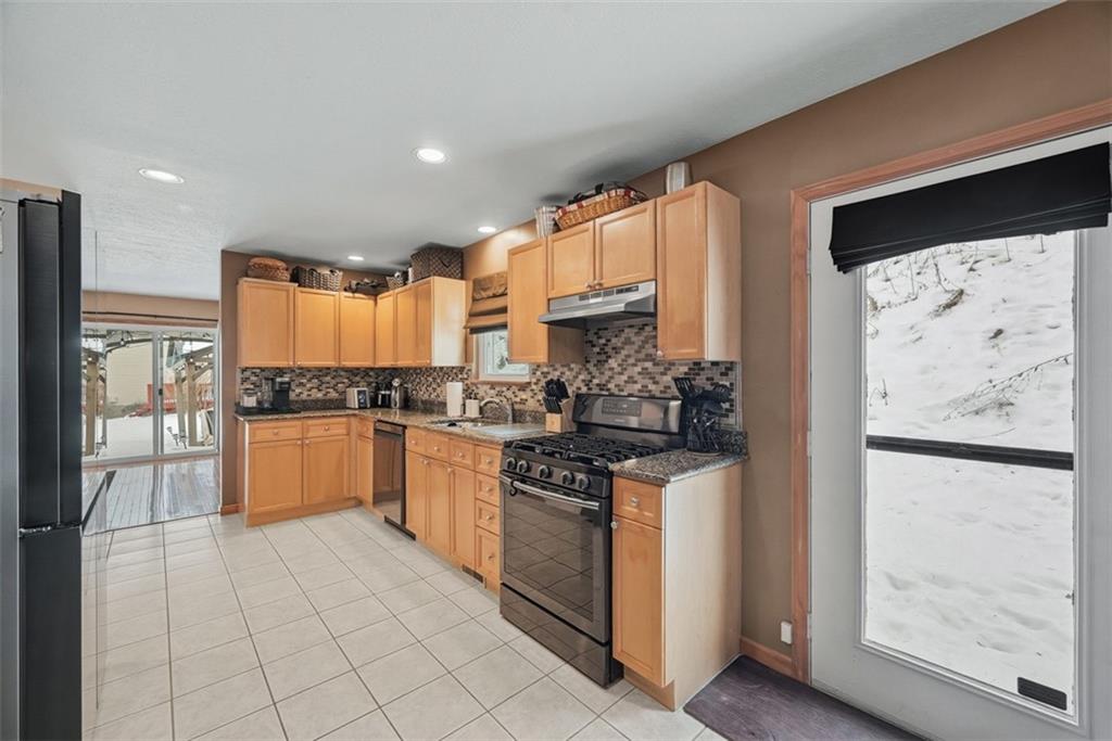 111 Greenhill Road Pittsburgh, PA 15237 - Photo 13 of 40 a kitchen with stainless steel appliances granite countertop a stove a sink and a refrigerator