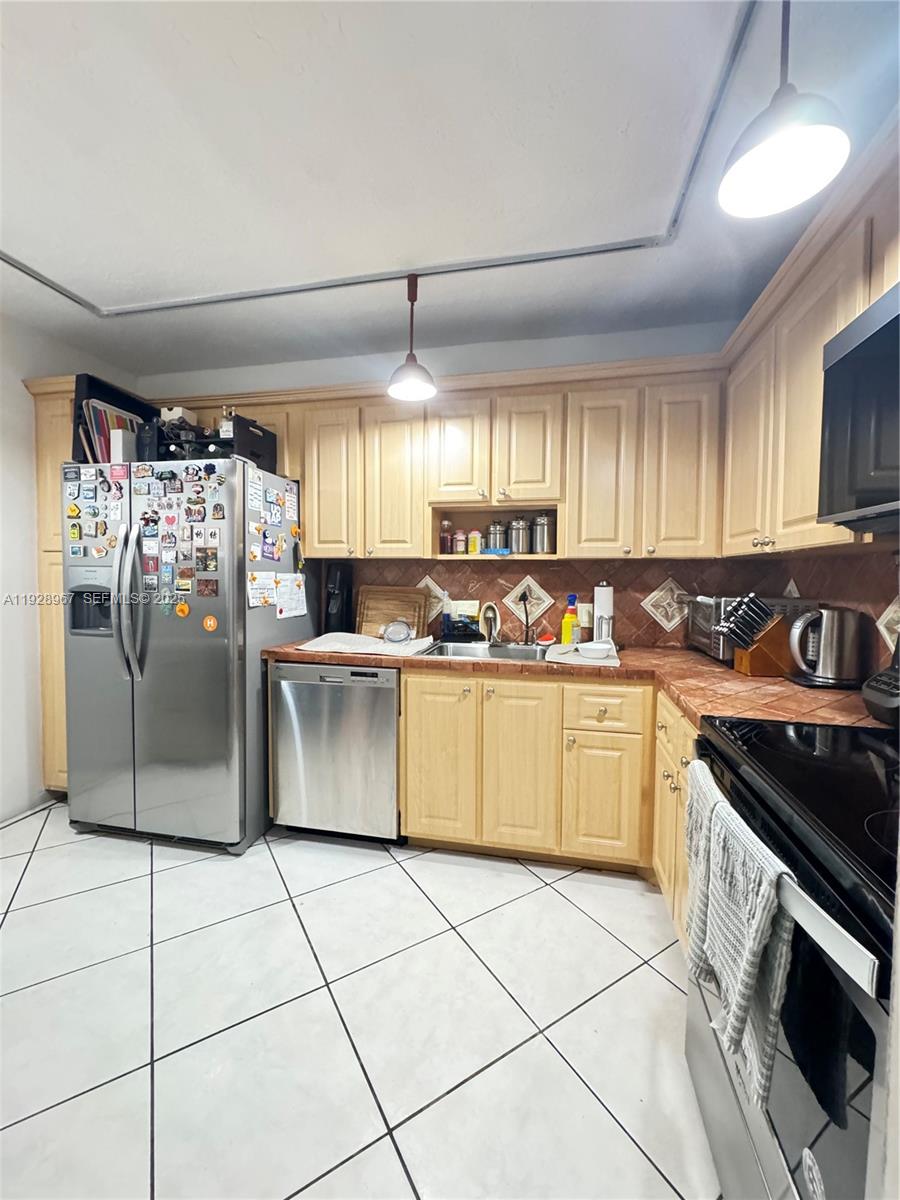 20100 West Country Club Drive, Unit 1606 Aventura, FL 33180 - Photo 3 of 10 a kitchen with stainless steel appliances granite countertop a stove a sink and a refrigerator