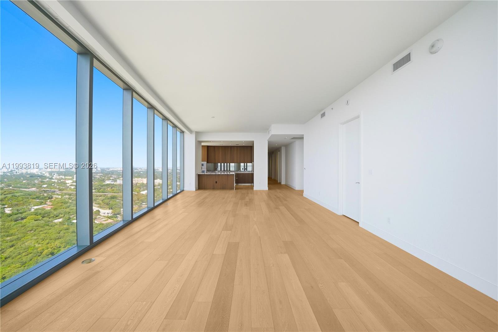 175 Southeast 25th Road, Unit 3102 Miami, FL 33129 - Photo 12 of 65 a view of empty room with wooden floor and floor to ceiling window
