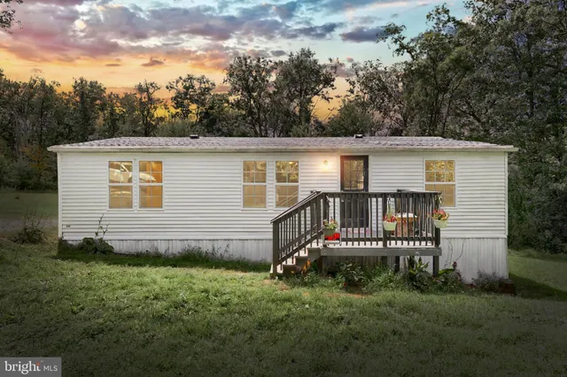 a front view of a house with a garden and plants
