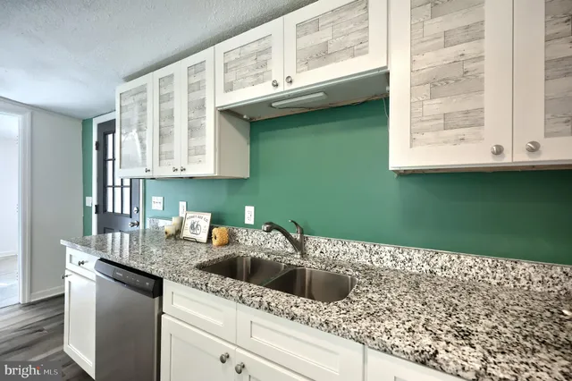 a kitchen with a sink and cabinets