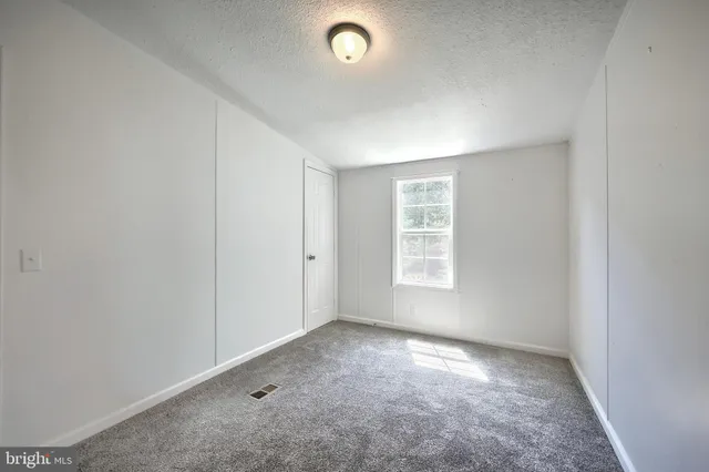 an empty room with a empty space and windows