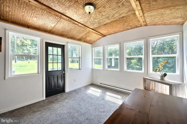 a view of an entryway with wooden floor