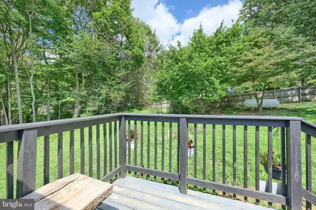 a view of balcony with deck and yard