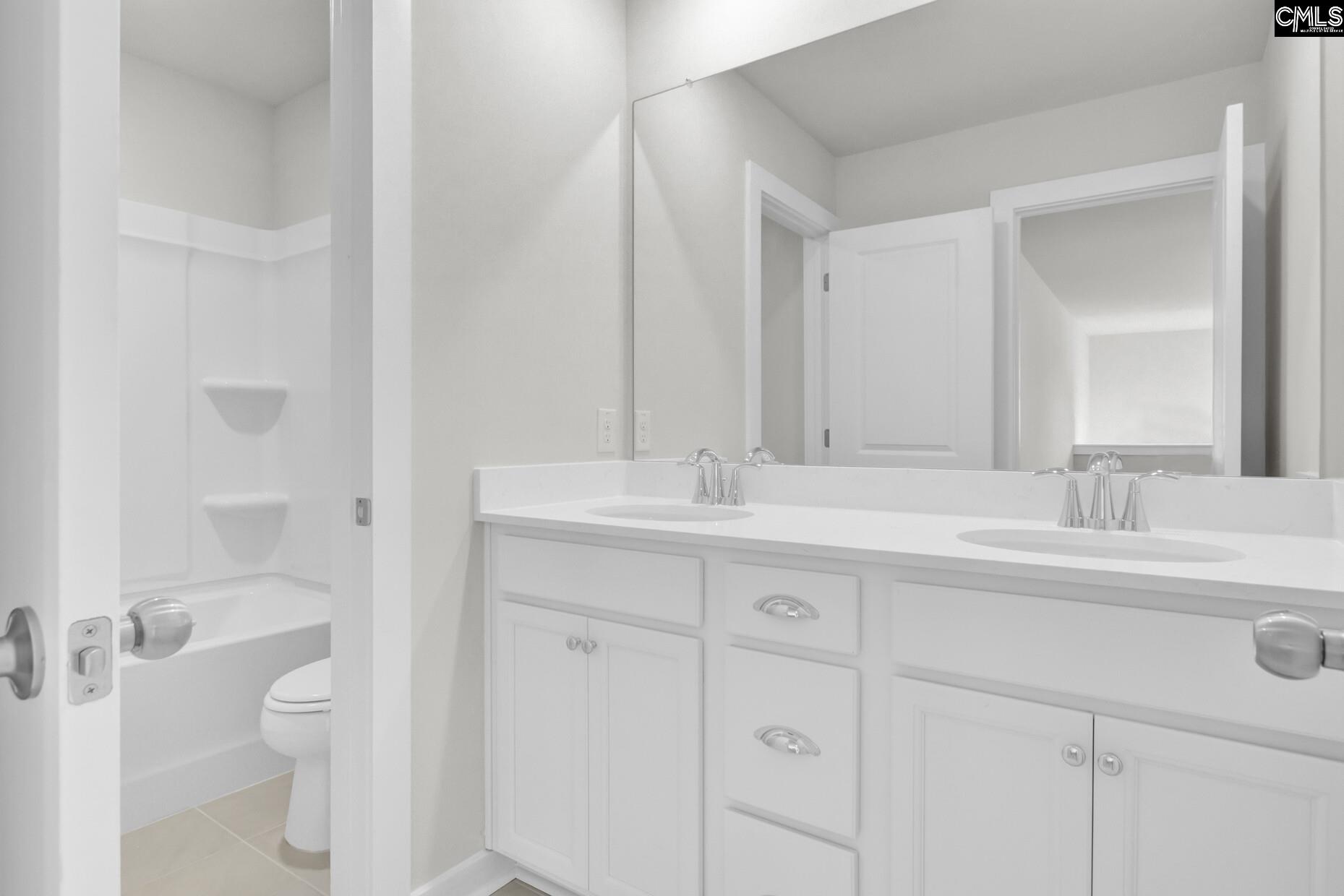 320 Brass Billion Path Lexington, SC 29073 - Photo 27 of 39 a bathroom with a sink a toilet and a large mirror
