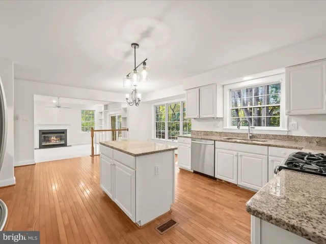 a view of an empty room with a window and fireplace