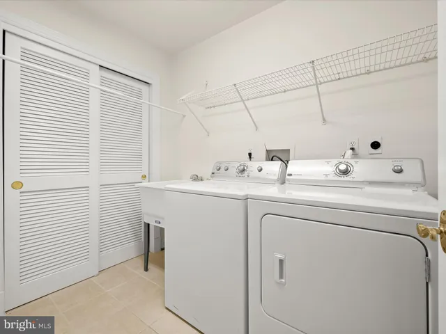 a view of an empty room with wooden cabinets