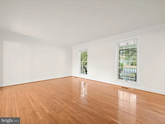 a view of a dining room with furniture a chandelier and wooden floor